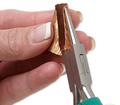 metal sheet being curved with pliers